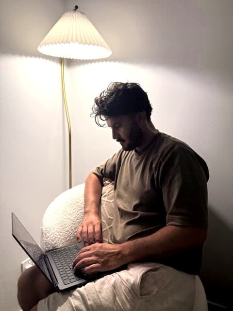 Syed Mosawi, founder of Responsible AI Australia, vibe coding on a laptop late at night